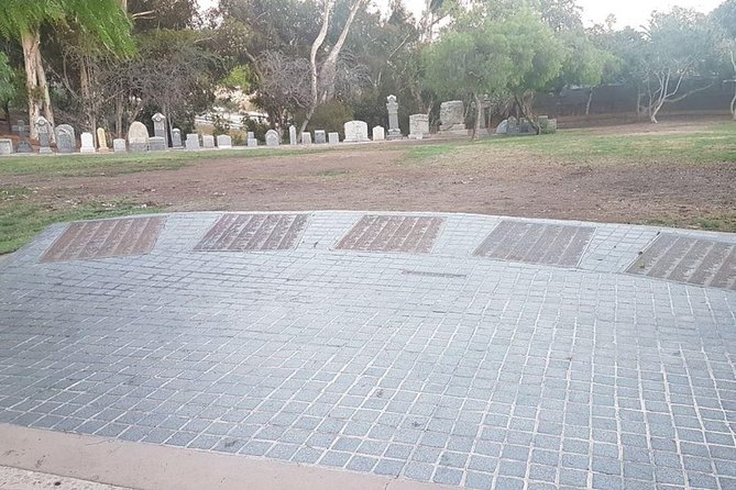 San Diego Ghosts and Gravestones: A Haunted Trolley Tour - Pioneer Park after dark: lanterns, shadows, and story acting